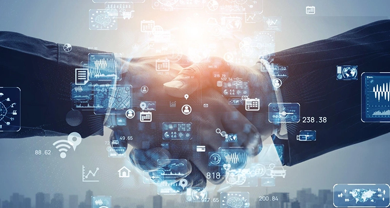 Two business professionals shaking hands with digital data overlays, representing MSPwiz partnership building through MSP matchmaking.